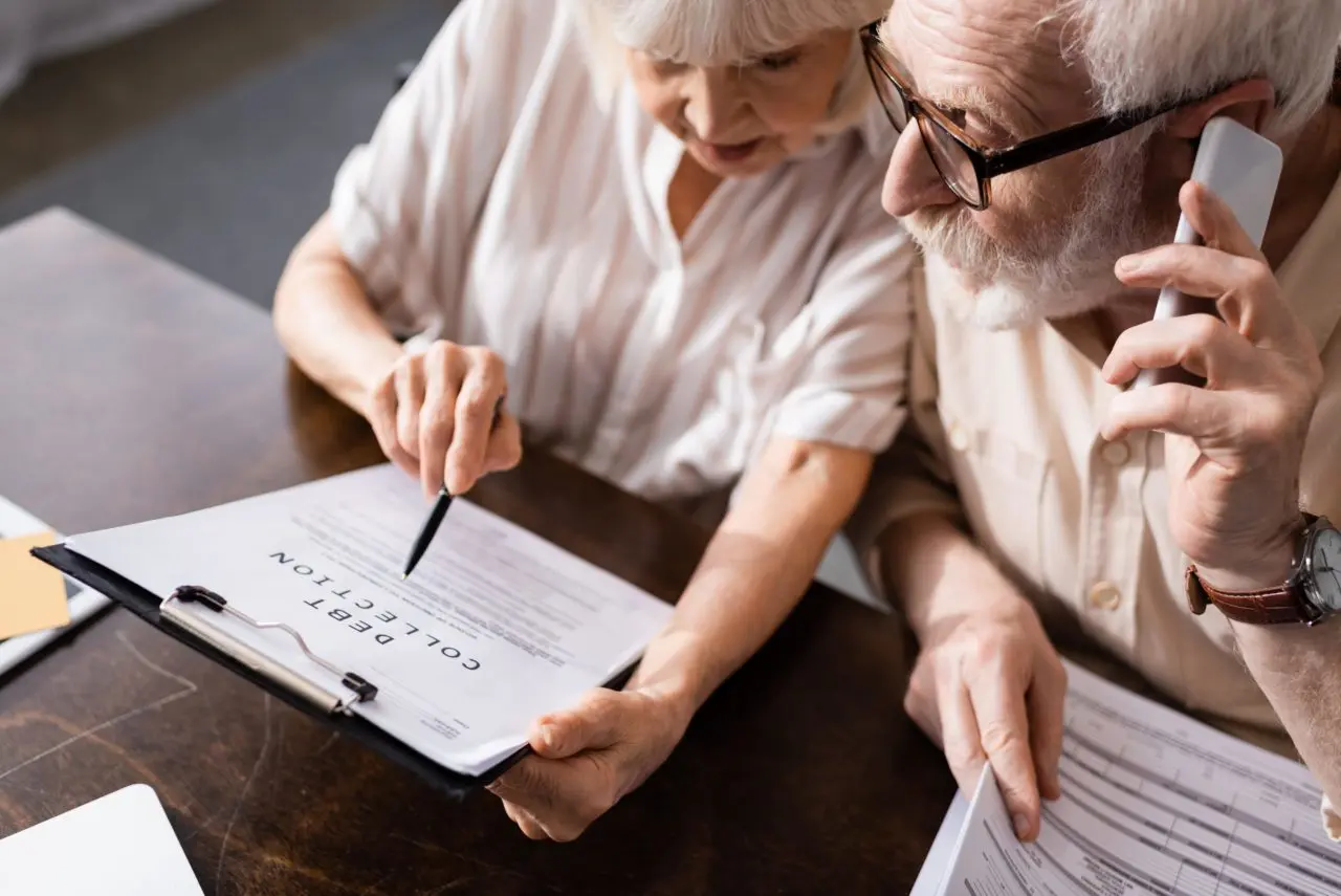 High angle view of elderly couple going over paperwork